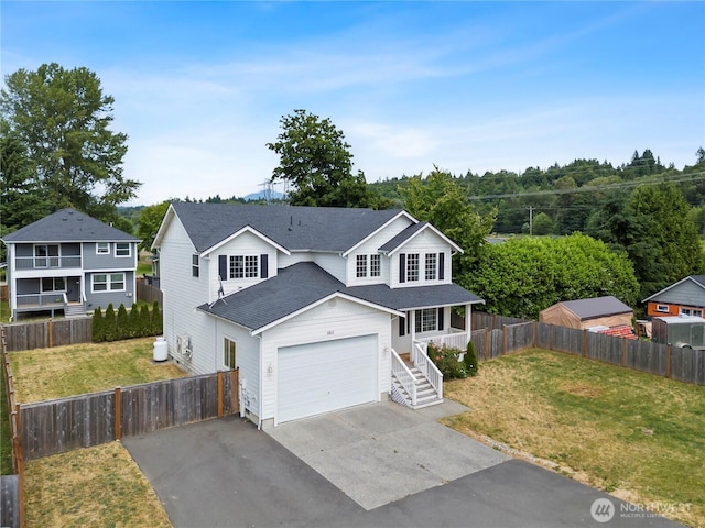 1611 Austin Ave, Snohomish, WA 98290 - traditional-style home featuring asphalt driveway, a porch, roof with shingles, and a garage