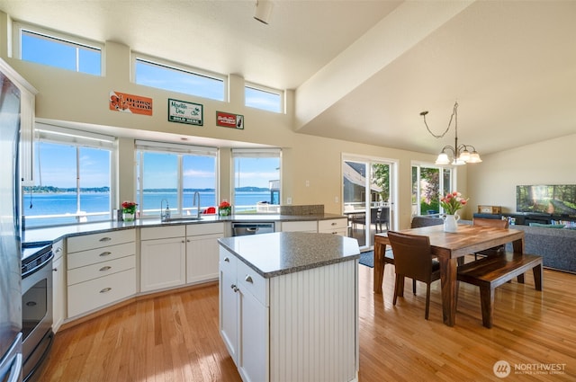 9340 SE Cornell Rd, Port Orchard, WA 98366 - kitchen with stainless steel appliances, light wood-style flooring, healthy amount of natural light, a chandelier, and high vaulted ceiling