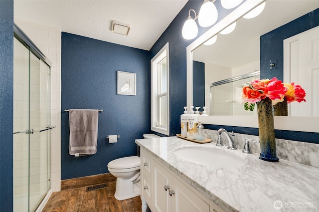 9340 SE Cornell Rd, Port Orchard, WA 98366 - bathroom with wood finished floors, a shower stall, a textured wall, and vanity