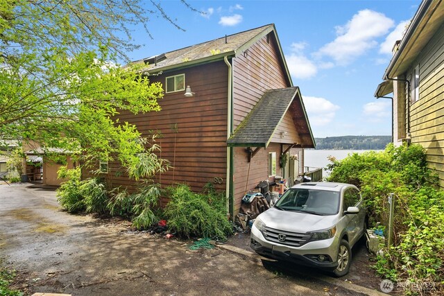 80 E Rose Point Ln, Belfair, WA 98528 - view of home's exterior featuring roof with shingles