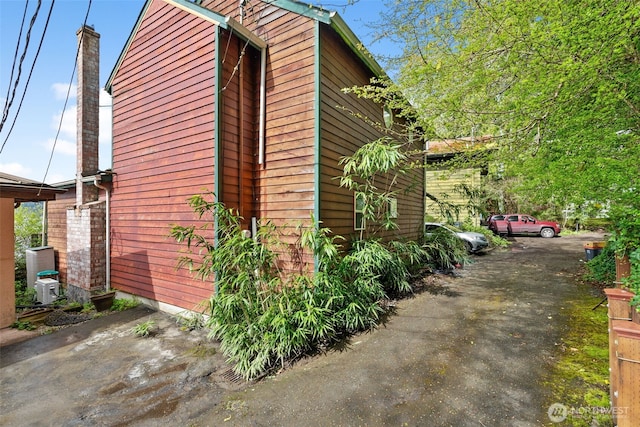 80 E Rose Point Ln, Belfair, WA 98528 - view of side of property featuring a chimney