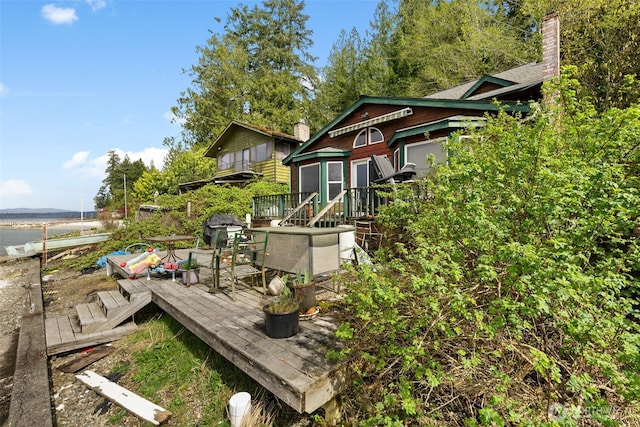 80 E Rose Point Ln, Belfair, WA 98528 - view of home's exterior with a chimney and a wooden deck