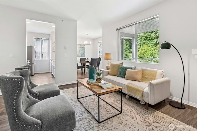 3006 SE 8th St Unit 2120, Renton, WA 98058 - living area with a chandelier, wood finished floors, and plenty of natural light