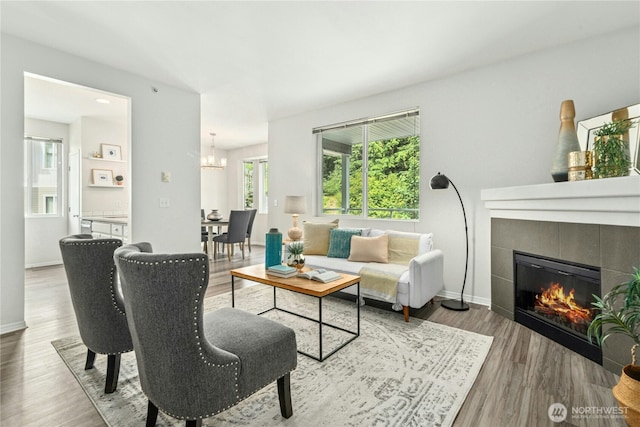 3006 SE 8th St Unit 2120, Renton, WA 98058 - living area with a chandelier, wood finished floors, and a fireplace