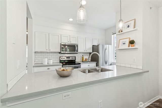 3006 SE 8th St Unit 2120, Renton, WA 98058 - kitchen with stainless steel appliances, backsplash, a peninsula, and decorative light fixtures