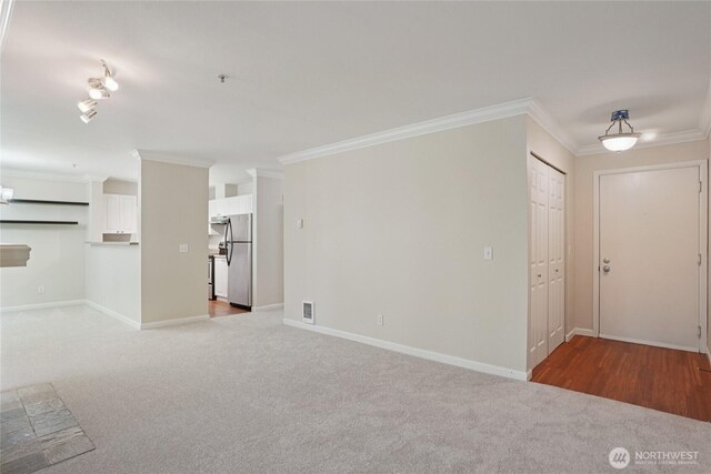 33020 10th Ave SW Unit E204, Federal Way, WA 98023 - unfurnished living room featuring crown molding and carpet floors