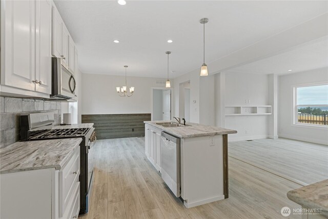 2204 Dublin Pl, Anacortes, WA 98221 - kitchen featuring appliances with stainless steel finishes, white cabinetry, light wood-style flooring, tasteful backsplash, and recessed lighting