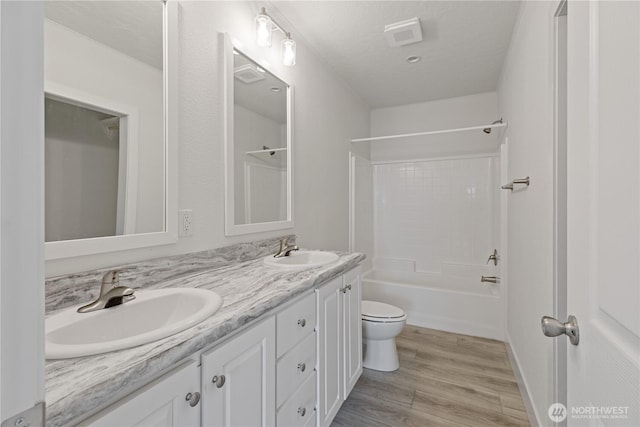 2204 Dublin Pl, Anacortes, WA 98221 - full bathroom featuring double vanity, wood finished floors, and shower / bathtub combination
