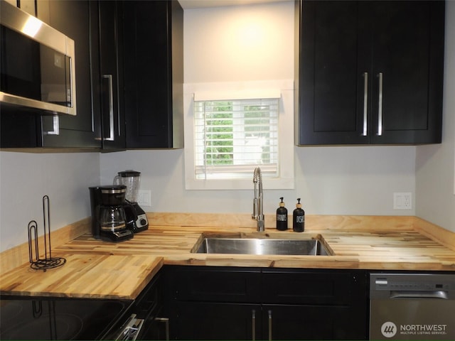 14806 131st Ave SE, Renton, WA 98058 - kitchen with wood counters, appliances with stainless steel finishes, and dark cabinets