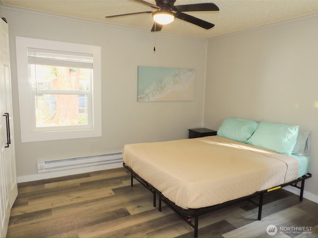 14806 131st Ave SE, Renton, WA 98058 - bedroom with baseboard heating, ornamental molding, wood finished floors, and a ceiling fan
