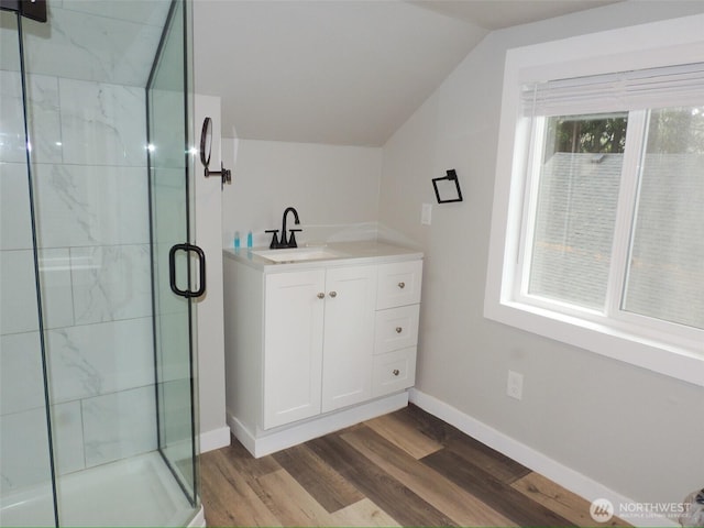 14806 131st Ave SE, Renton, WA 98058 - bathroom with a marble finish shower, wood finished floors, vaulted ceiling, and vanity