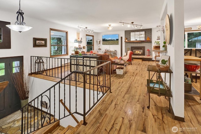 2815 Willis St, Bellingham, WA 98225 - stairs with wood-type flooring, rail lighting, and a fireplace