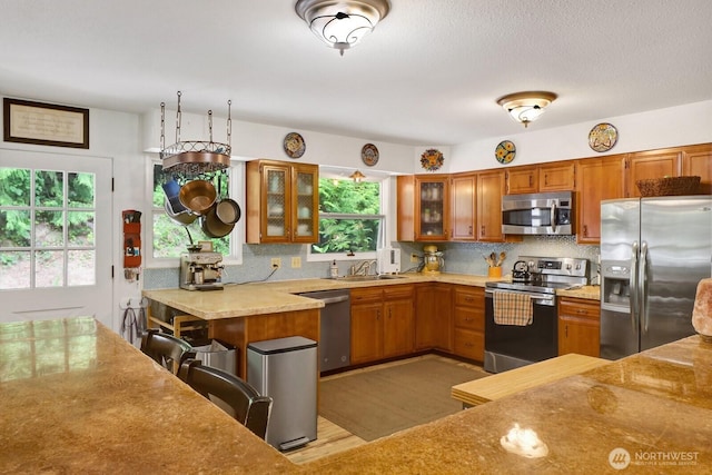 2815 Willis St, Bellingham, WA 98225 - kitchen with stainless steel appliances, brown cabinetry, and light countertops
