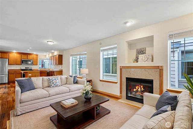 10736 Whitman Ave N, Seattle, WA 98133 - living room featuring wood finished floors, a glass covered fireplace, and recessed lighting