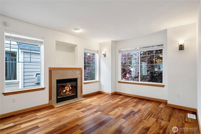 10736 Whitman Ave N, Seattle, WA 98133 - unfurnished living room with wood finished floors and a glass covered fireplace