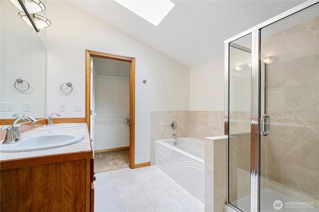 10736 Whitman Ave N, Seattle, WA 98133 - full bathroom featuring a skylight, vaulted ceiling, a garden tub, double vanity, and a shower stall