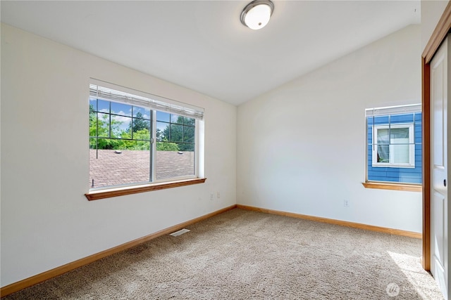 10736 Whitman Ave N, Seattle, WA 98133 - carpeted empty room featuring vaulted ceiling and baseboards