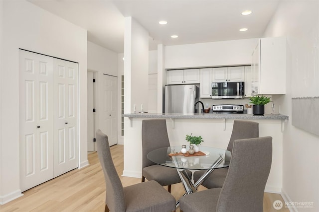122 S State St Unit 207E, Kirkland, WA 98033 - dining area with light wood-style flooring and recessed lighting