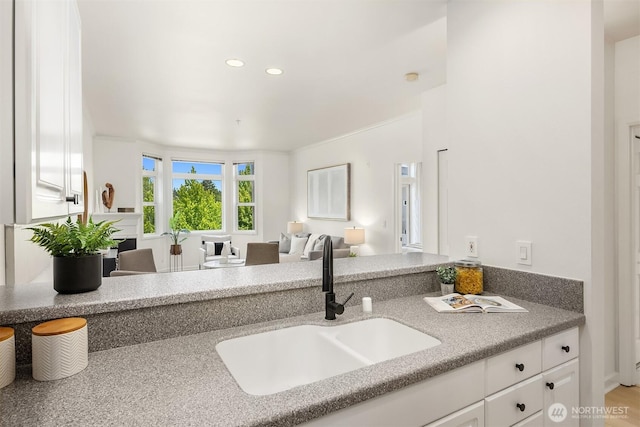 122 S State St Unit 207E, Kirkland, WA 98033 - kitchen featuring open floor plan, white cabinetry, recessed lighting, and light stone countertops