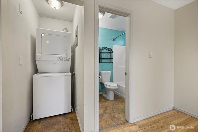 1220 S 313th St, Federal Way, WA 98003 - laundry room featuring estacked washer and dryer and stone finish floors