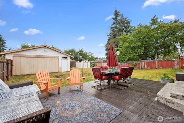 1220 S 313th St, Federal Way, WA 98003 - deck with a storage unit, outdoor dining area, and a fenced backyard