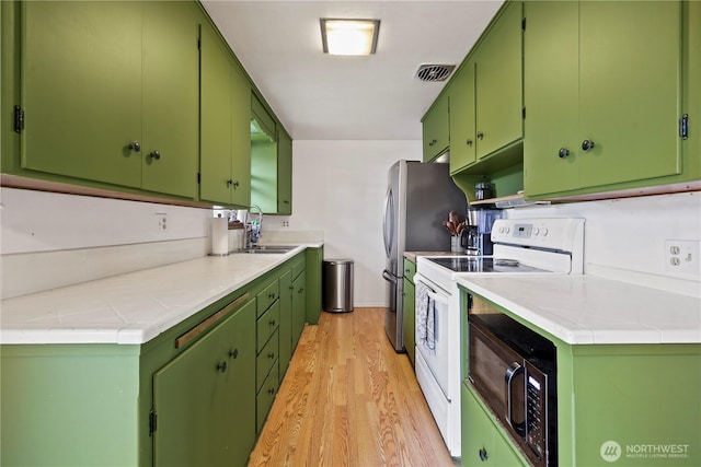 1220 S 313th St, Federal Way, WA 98003 - kitchen featuring white electric range oven, light wood-style flooring, and black microwave