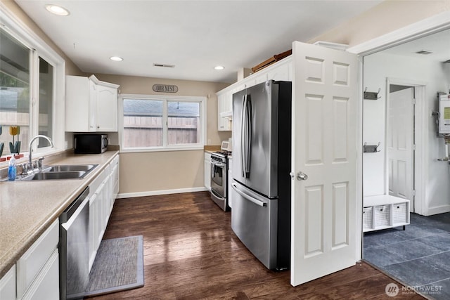 825 Main St, Lynden, WA 98267 - kitchen featuring stainless steel appliances, white cabinets, dark wood-style floors, light countertops, and recessed lighting