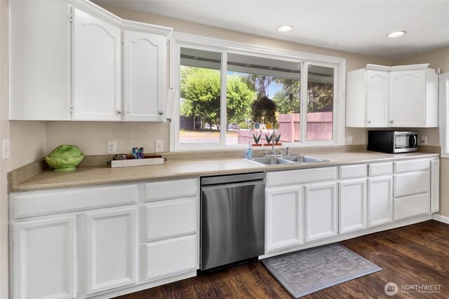 825 Main St, Lynden, WA 98267 - kitchen featuring appliances with stainless steel finishes, white cabinets, light countertops, dark wood-type flooring, and recessed lighting