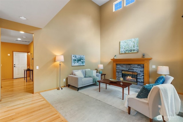 18328 10th Dr SE, Bothell, WA 98012 - living room featuring light wood finished floors, a high ceiling, and a fireplace