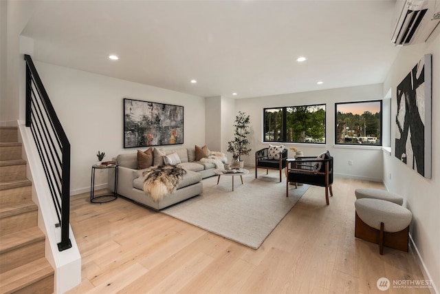 5606 23rd Ave SW, Seattle, WA 98106 - living room featuring a wall mounted air conditioner, light wood-type flooring, stairs, and recessed lighting