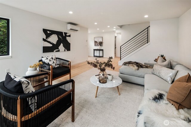 5606 23rd Ave SW, Seattle, WA 98106 - living room with a wall unit AC, stairs, wood finished floors, and recessed lighting