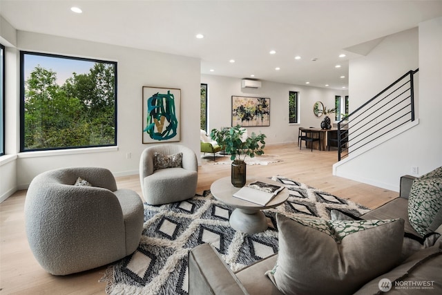 5606 23rd Ave SW, Seattle, WA 98106 - living room featuring a wall unit AC, stairway, light wood-style flooring, and recessed lighting