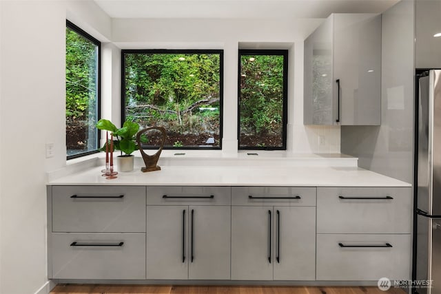 5606 23rd Ave SW, Seattle, WA 98106 - bar featuring freestanding refrigerator and plenty of natural light