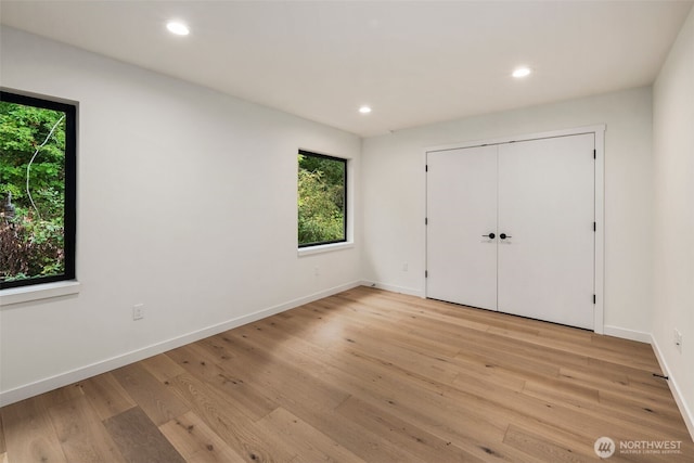5606 23rd Ave SW, Seattle, WA 98106 - unfurnished bedroom featuring light wood-type flooring, recessed lighting, and a closet