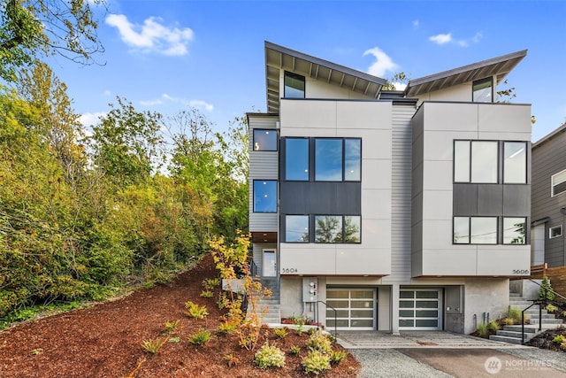 5606 23rd Ave SW, Seattle, WA 98106 - view of building exterior featuring stairs, a garage, and driveway