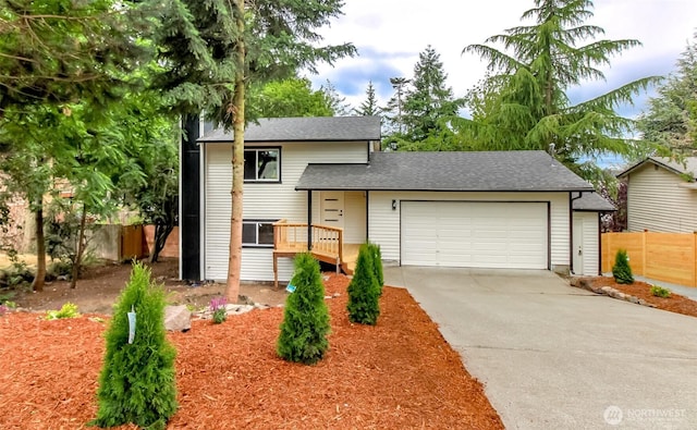 21241 S 29th Ave, Seatac, WA 98198 - split level home featuring driveway, an attached garage, and roof with shingles