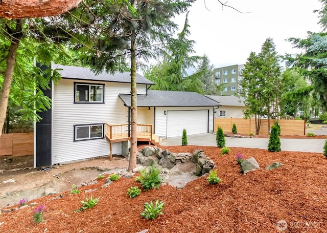 21241 S 29th Ave, Seatac, WA 98198 - split level home with concrete driveway, an attached garage, and roof with shingles