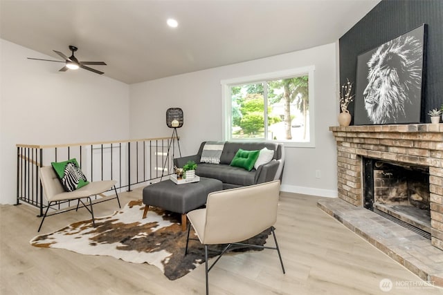 21241 S 29th Ave, Seatac, WA 98198 - living room with wood finished floors, a ceiling fan, and a fireplace