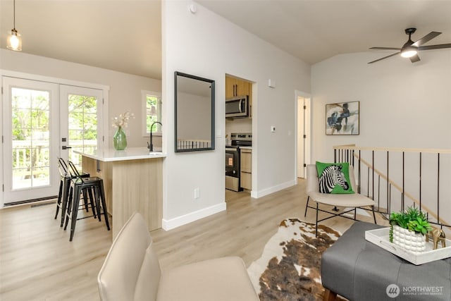 21241 S 29th Ave, Seatac, WA 98198 - living area featuring lofted ceiling, light wood finished floors, ceiling fan, and french doors