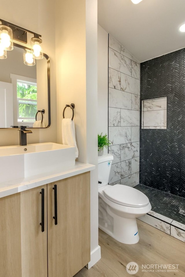 21241 S 29th Ave, Seatac, WA 98198 - full bath with wood finished floors, vanity, and a tile shower