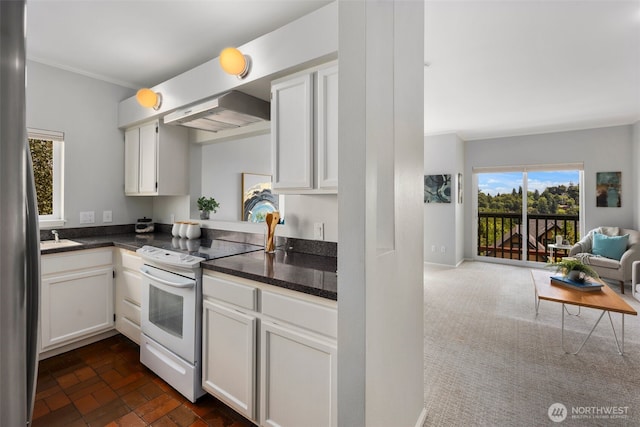1812 25th Ave Unit C, Seattle, WA 98122 - kitchen featuring white electric stove, wall chimney exhaust hood, dark countertops, open floor plan, and crown molding