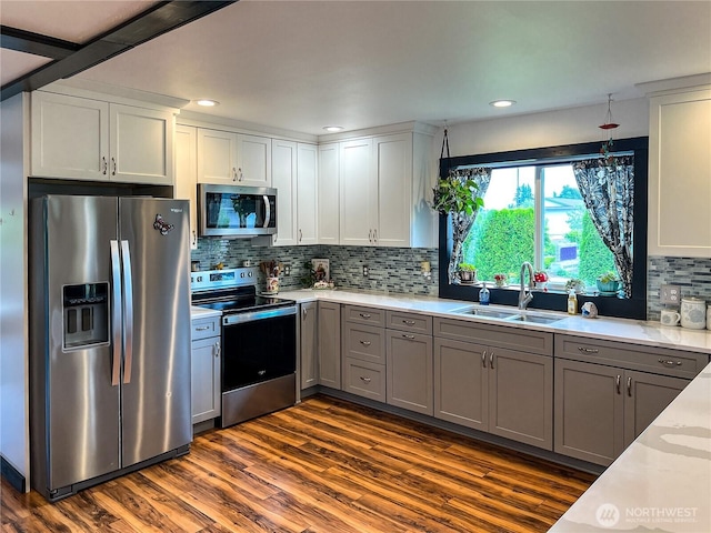 242 Morton St, Sumas, WA 98295 - kitchen featuring stainless steel appliances, dark wood-type flooring, decorative backsplash, gray cabinetry, and white cabinetry