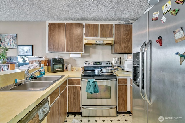 1823 M St NE Unit 1823, Auburn, WA 98002 - kitchen with appliances with stainless steel finishes, extractor fan, a textured ceiling, light countertops, and light flooring