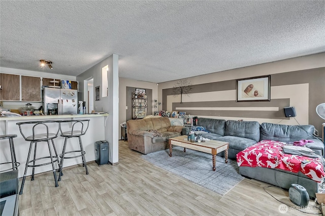 1823 M St NE Unit 1823, Auburn, WA 98002 - living room with light wood-style floors and a textured ceiling