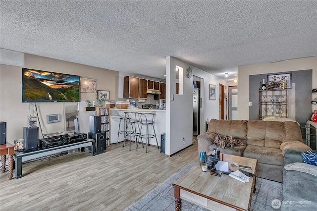1823 M St NE Unit 1823, Auburn, WA 98002 - living area featuring light wood-style floors and a textured ceiling