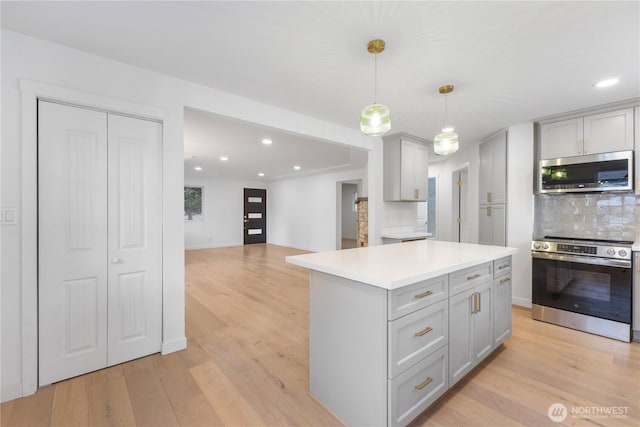 10303 40th Ave E, Tacoma, WA 98446 - kitchen featuring stainless steel microwave, gray cabinetry, wall oven, decorative backsplash, and recessed lighting