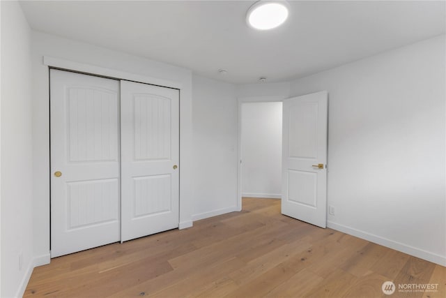 10303 40th Ave E, Tacoma, WA 98446 - unfurnished bedroom featuring light wood-type flooring and a closet