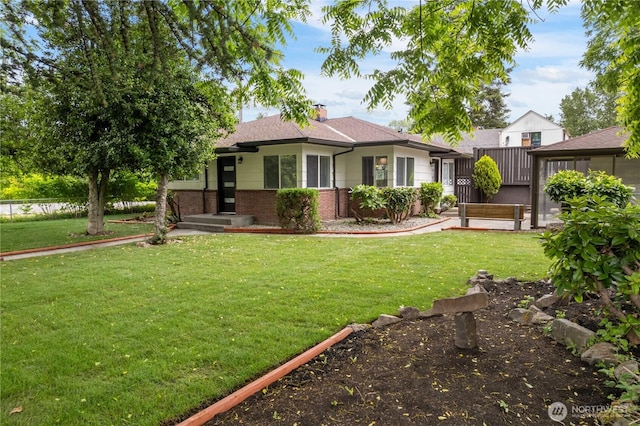 10303 40th Ave E, Tacoma, WA 98446 - view of front of home featuring brick siding, a front yard, and a chimney