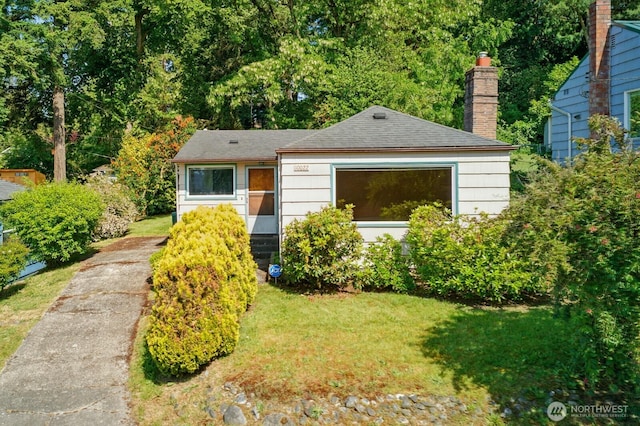 10022 8th Ave NE, Seattle, WA 98125 - view of front facade with a front yard, a chimney, and a shingled roof