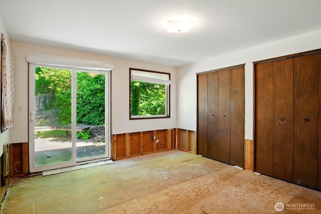 10022 8th Ave NE, Seattle, WA 98125 - unfurnished bedroom with multiple windows and two closets